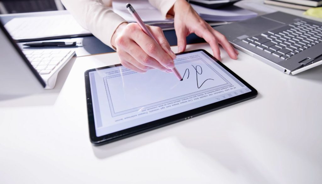 The woman is using electronic signature.