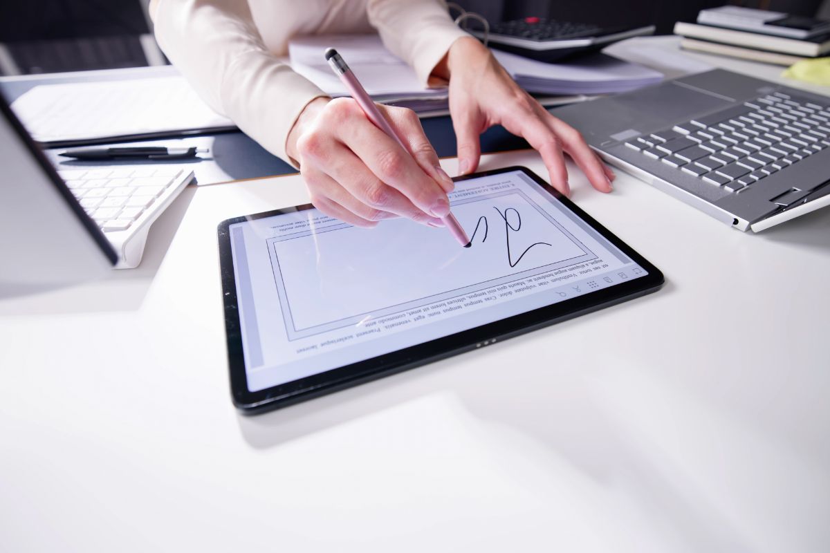 The woman is using electronic signature.