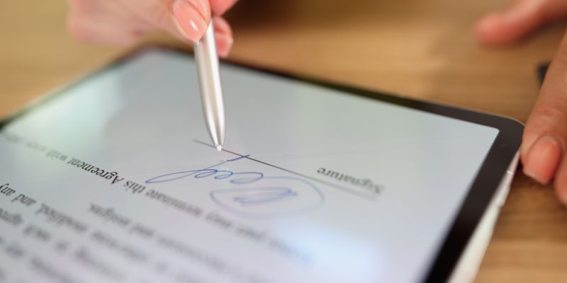 The person adds a signature in a PDF document.