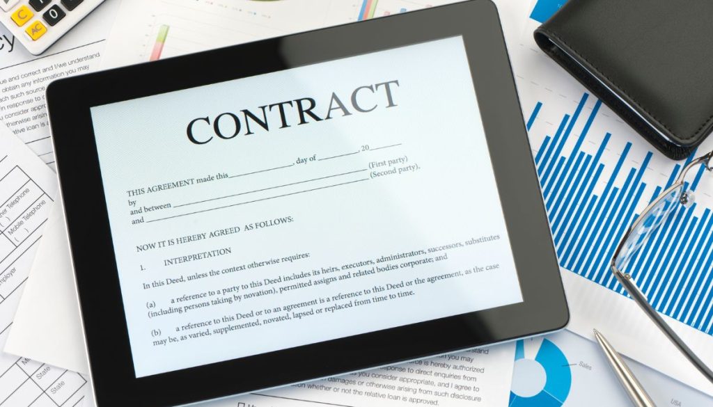 The iPad shows an online contract.