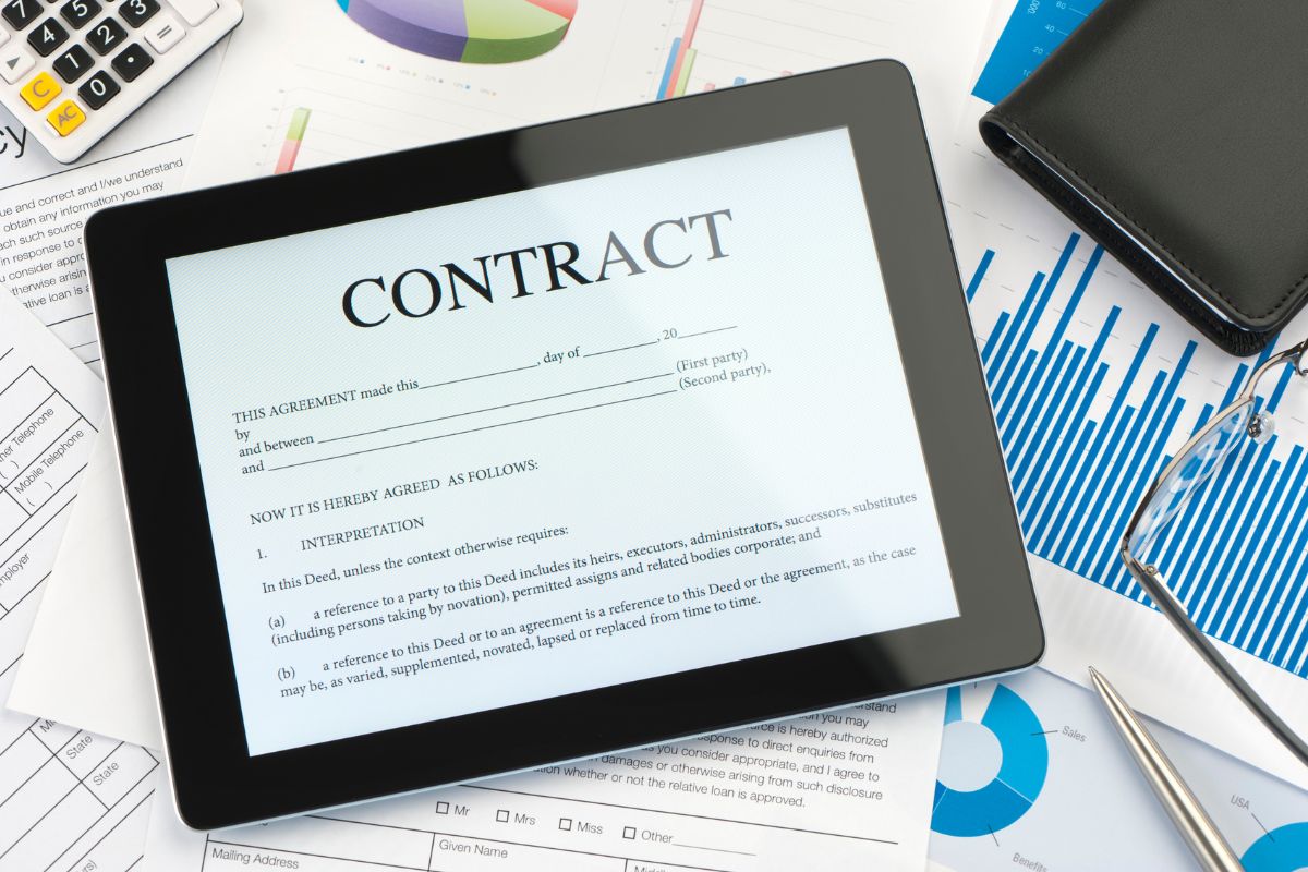 The iPad shows an online contract.