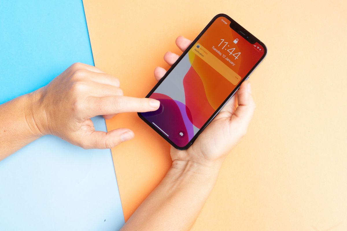 The person uses his iPhone to sign documents.