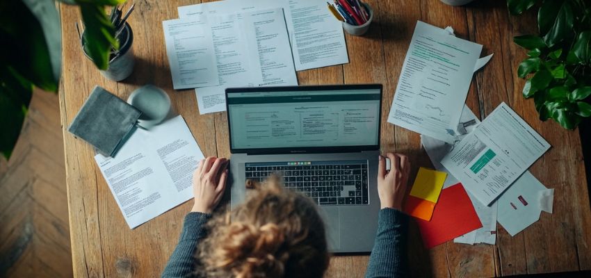 The woman is using an electronic signature software like AiSign.