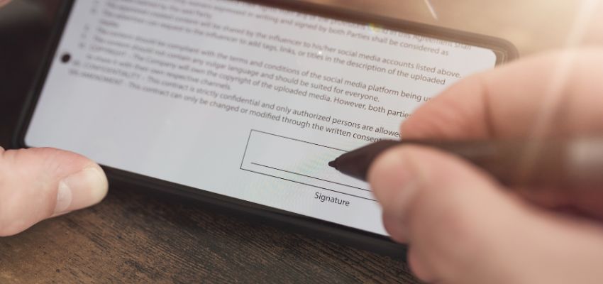 a man signing a digital document with a well-present signature block