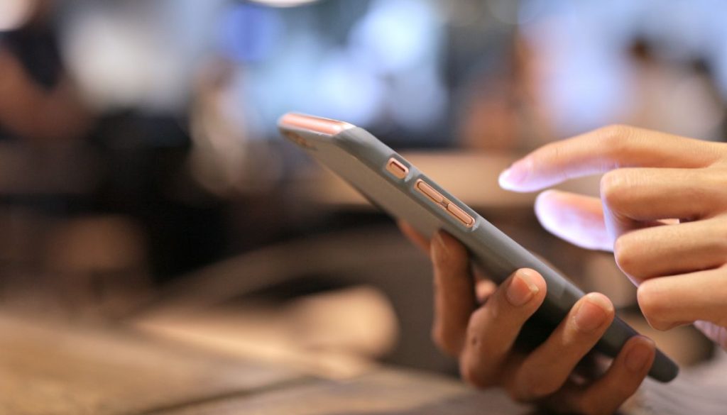 A woman using a mobile-friendly signing app for business.