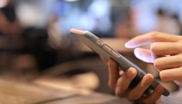 A woman using a mobile-friendly signing app for business.