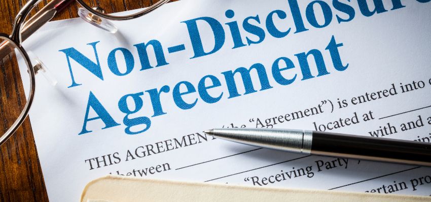 A close-up photo of a non-disclosure agreements contract and pen