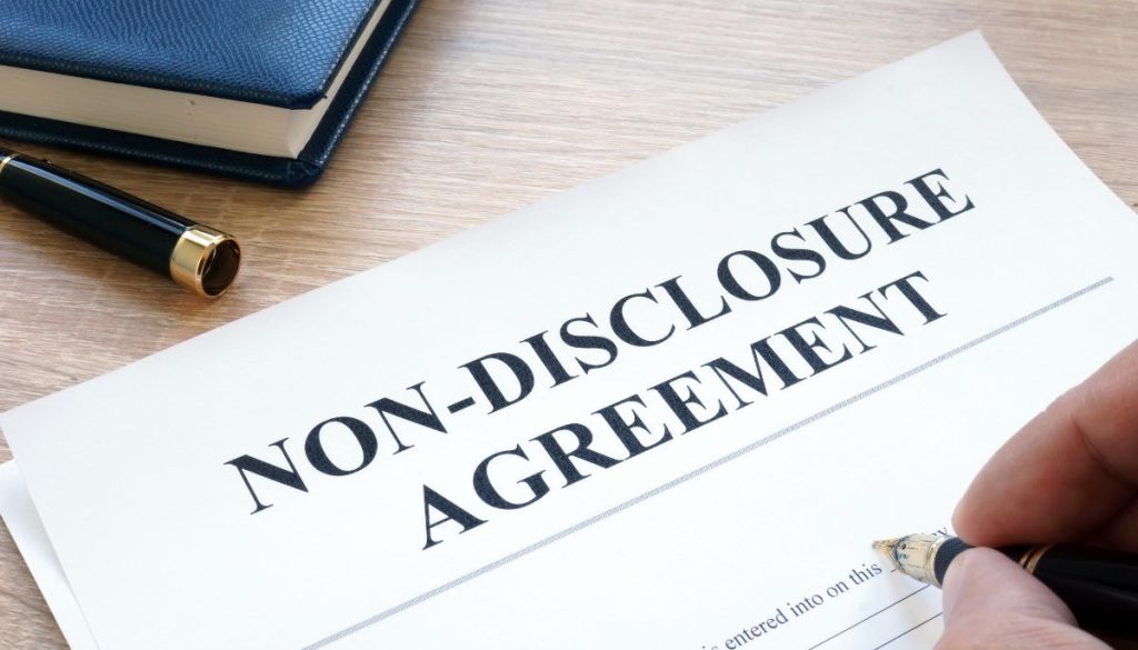 A professional holding signed non-disclosure agreements.