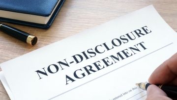 A professional holding signed non-disclosure agreements.