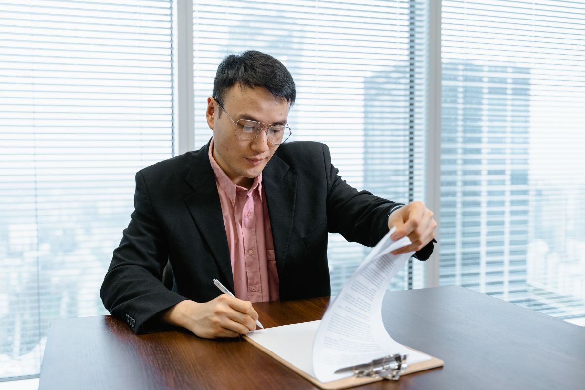 The businessman signs a business agreement.