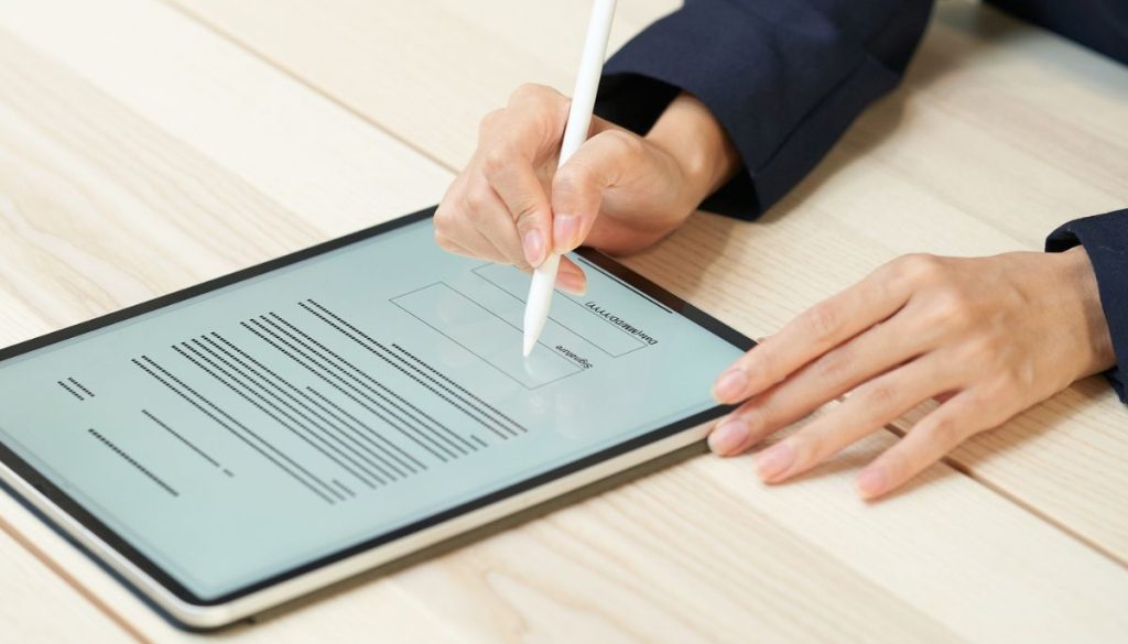 The businessman signs a digital contract.