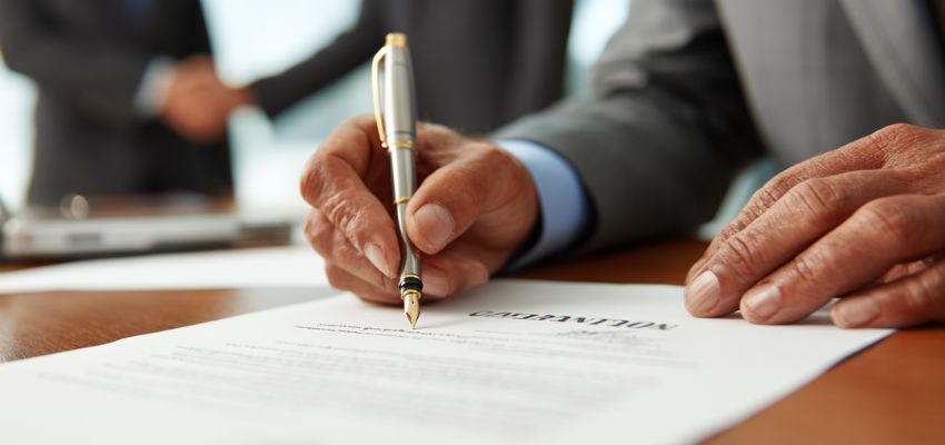 The businessman signs a contract.