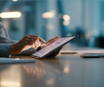 Close-up of hands using stylus to review contract strategies on a tablet device