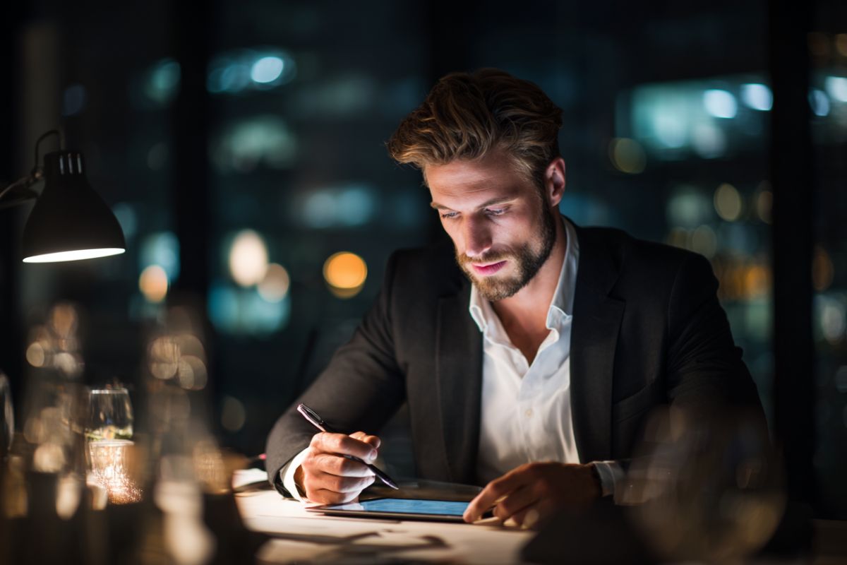 The businessman reviews the contract before signing it.