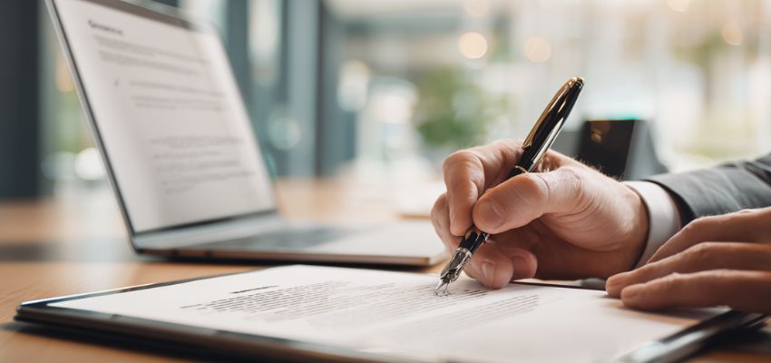 A person reviews a digital contract agreement before signing it.