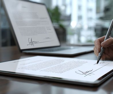 A person signs a contract agreement.